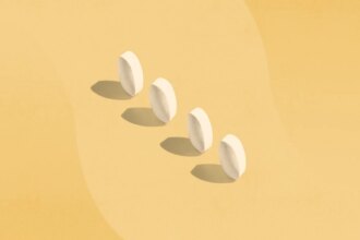 four white pills standing on end with shadows