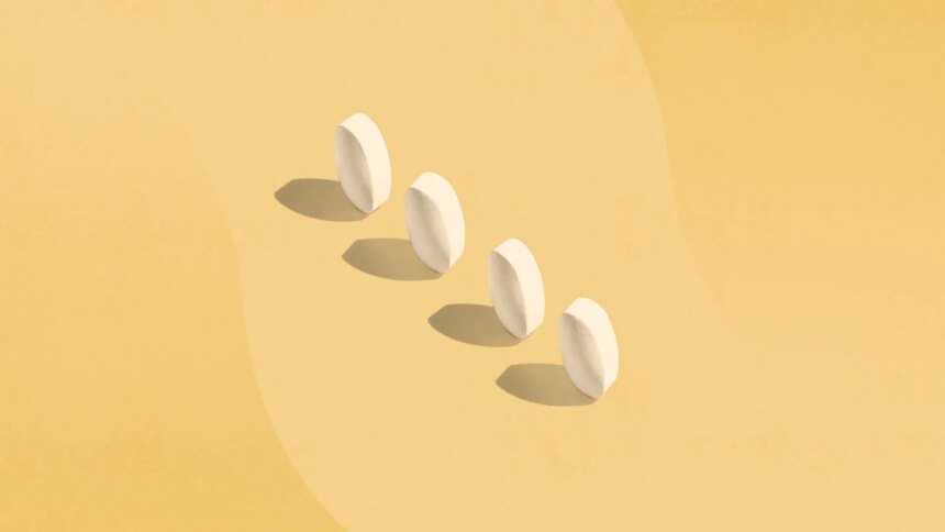 four white pills standing on end with shadows