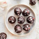 Close-up overhead shot of chocolate peppermint protein balls arranged on a plate.