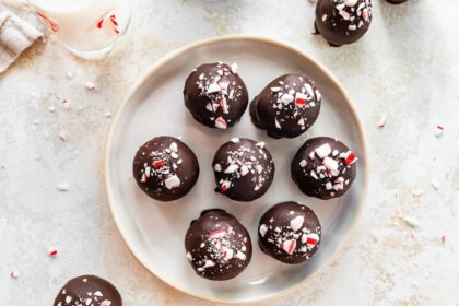 Close-up overhead shot of chocolate peppermint protein balls arranged on a plate.
