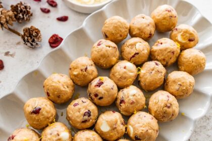 A white dish of cranberry orange protein balls.