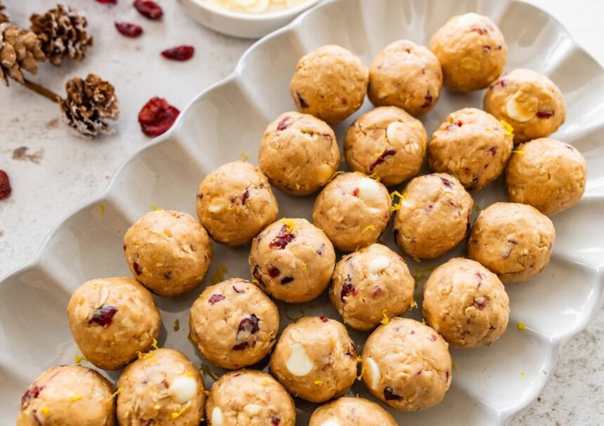 A white dish of cranberry orange protein balls.