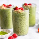 Matcha chia pudding in glass jars with strawberries and crunchy toppings for meal prep.