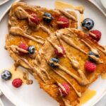 Single-serve protein French toast with blueberries, raspberries, and maple syrup.