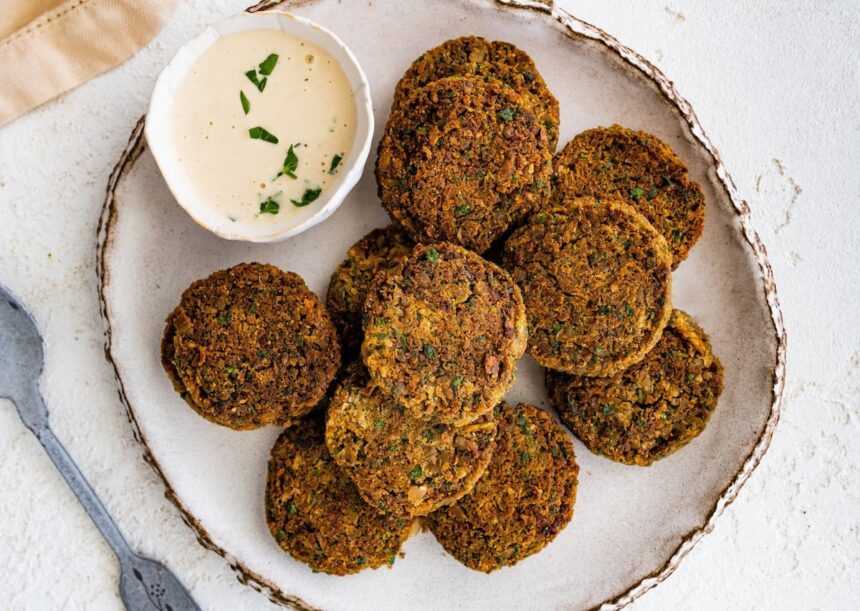 Close-up of golden baked falafel showing crispy edges and herb-filled texture.