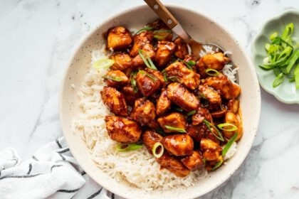 Sweet and savory glazed chicken served over fluffy rice in a bowl.