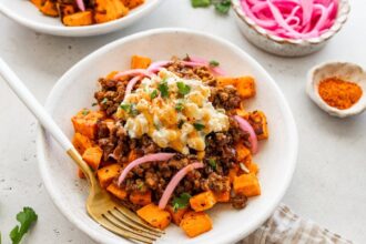 Roasted sweet potatoes topped with ground beef, street corn salsa, pickled red onions, cilantro and hot honey.